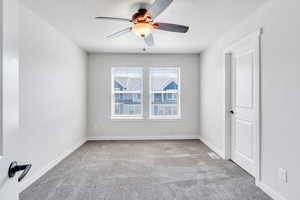 Carpeted  bedroom with ceiling fan