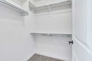 Walk in closet featuring carpet flooring