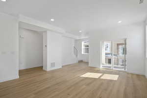 Unfurnished living room with light hardwood / wood-style floors