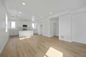 Unfurnished living room with light wood-type flooring