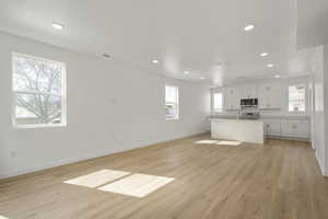 Unfurnished living room featuring light wood-type flooring