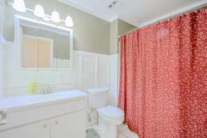 Bathroom with oversized vanity, toilet, and tile floors