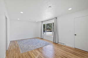 Unfurnished room with light hardwood / wood-style flooring