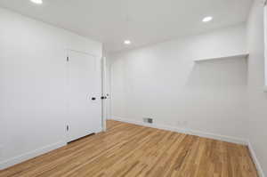 Empty room featuring light wood-type flooring