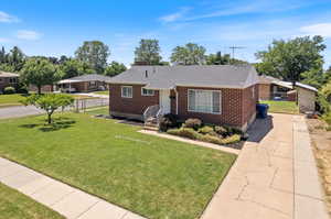 Single story home with a front lawn