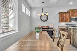 Dining area with a healthy amount of sunlight and light hardwood / wood-style floors