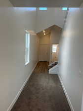 Interior space featuring carpet flooring and lofted ceiling