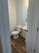 Bathroom with toilet and hardwood / wood-style floors