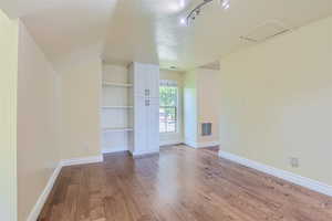 Interior space featuring hardwood / wood-style floors and rail lighting