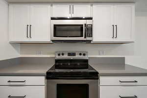 Kitchen with stainless steel appliances and white cabinets