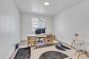 Home office with hardwood / wood-style flooring