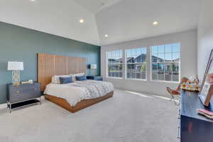 Carpeted bedroom featuring high vaulted ceiling