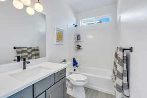 Full bathroom featuring shower / tub combination, oversized vanity, and toilet