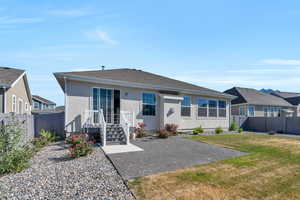 Rear view of property with a yard