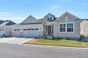 Craftsman inspired home with a front yard and a garage