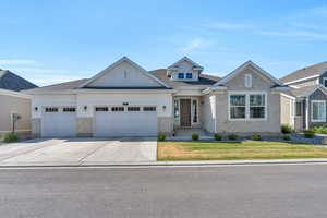 View of front of house featuring a garage and a front lawn