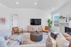 Living room featuring light hardwood / wood-style floors and lofted ceiling