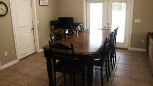 Tiled dining space with french doors and a wealth of natural light