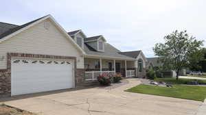 View of front of house featuring a garage and a porch