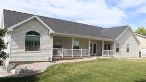 View of front facade with a front lawn and a porch