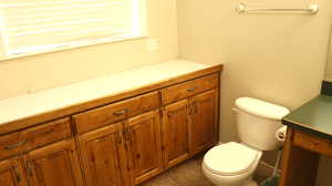 Bathroom with tile flooring, toilet, and vanity