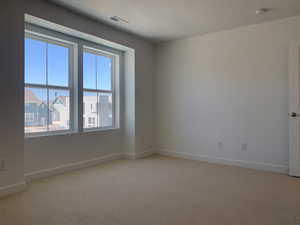 Carpeted spare room featuring a textured ceiling