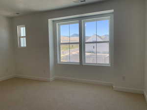 Unfurnished room featuring carpet