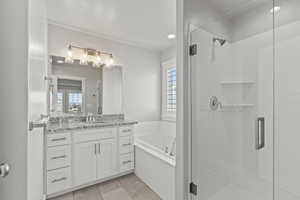 Bathroom featuring vanity and independent shower and bath