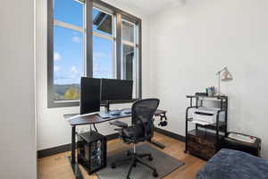 Office space with wood finished floors and baseboards