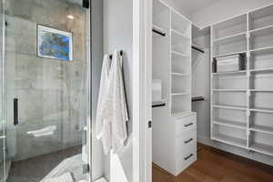 Spacious closet with dark wood finished floors