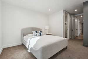 Bedroom featuring carpet floors, baseboards, recessed lighting, and a walk in closet
