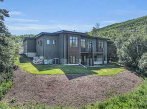 Back of house with a patio, central AC, and a lawn