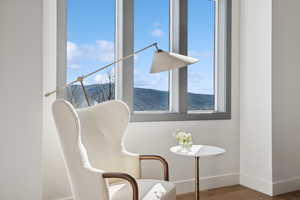 Living area with wood finished floors, baseboards, and a mountain view