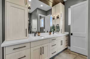 Bathroom featuring tile flooring and dual vanity