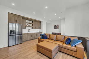 Living room with sink and light hardwood / wood-style floors