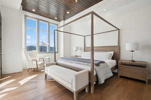 Bedroom with wood-type flooring, recessed lighting, wood ceiling, and baseboards