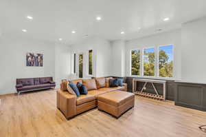 Living room with light hardwood / wood-style floors