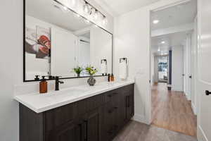 Bathroom with double vanity and baseboards