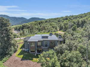 Exterior space featuring a mountain view and a lawn