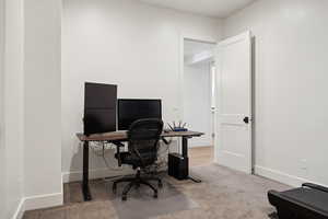 Office area featuring carpet and baseboards