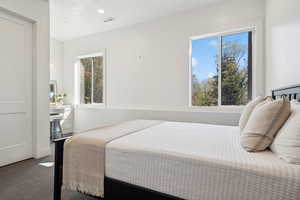 Bedroom featuring multiple windows and carpet