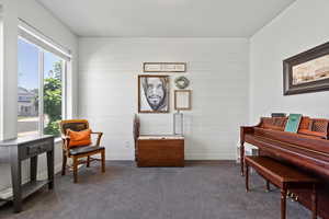 Office or sitting room featuring shiplap wall treatment