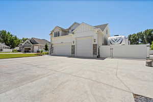 View of front of home with a garage and 93' concrete RV parking