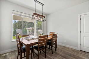 Expanded dining space featuring wood-style flooring