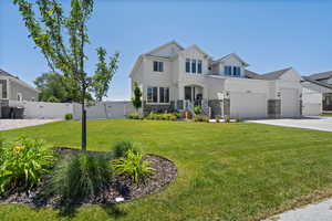 View of front of house featuring a front lawn and professional landscaping