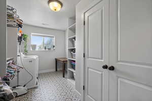 Large laundry room with shelves and closet