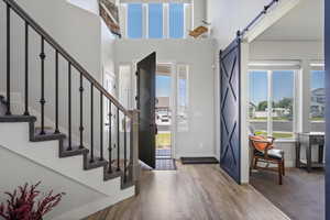 Entry with a high ceiling, a barn door entry to Office/sitting room