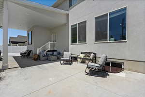 View of covered patio with an outdoor living space