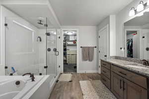 Ensuite bathroom featuring large walk in closet, oversized shower and soaking tub