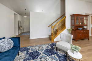 Living room featuring lofted ceiling and hardwood floors